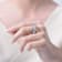 Oval CZ Band Ring In Rhodium Over Brass