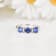 Blue Sapphire and Moissanite 3-Stone RingRhodium Over Sterling Silver
Round Lab Created