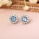 Round Blue Topaz with Moissanite Accents Rhodium Over Sterling Silver
Halo Earrings