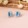 Swiss Blue Topaz with Moissanite  Rhodium Over Sterling Silver Halo Stud
Silver Earrings