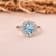 Blue Topaz with Moissanite Accents Sterling Silver Halo Ring