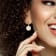 1/6 CT TGW White Topaz with White Enamel Flower Hoop Earrings in Yellow
Plated Sterling Silver