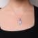 18K White Gold Pear Blue Topaz and Blue Sapphire and Diamond Drop
Pendant with Flower Design
