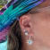 Sterling Silver Sun Dangle Earrings with Blue CZ Centers.