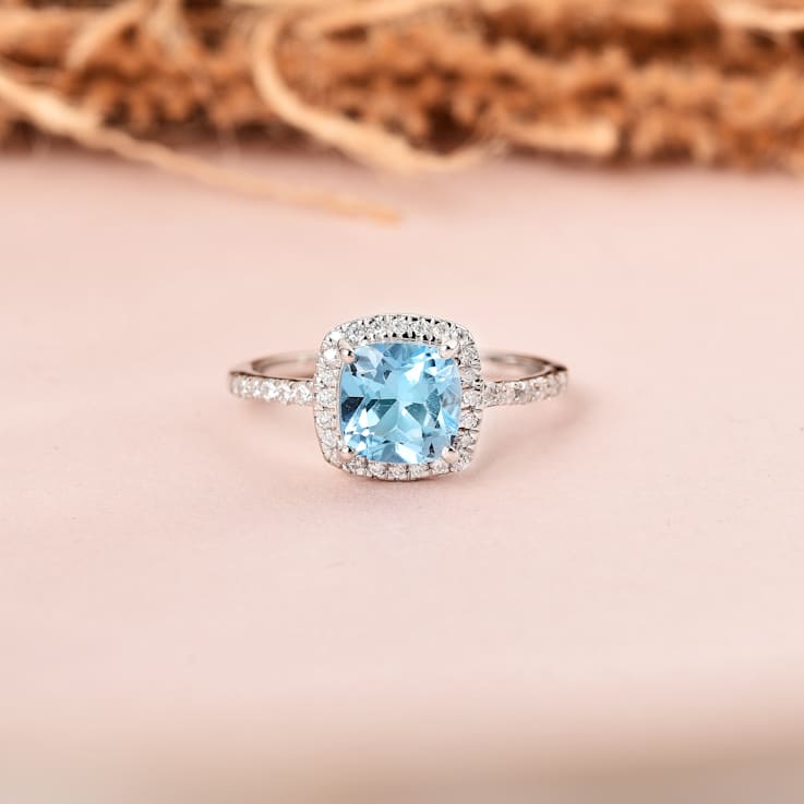 Cushion Swiss Blue Topaz with Moissanite Accents Rhodium Over Sterling
Silver Halo Ring 1.75ctw