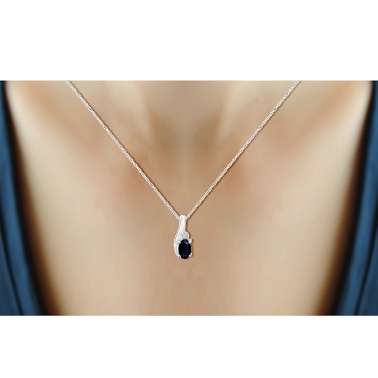 0.28ct Oval Black Sapphire with White Diamond Accent Rhodium Over
Sterling Silver Pendant with Chain