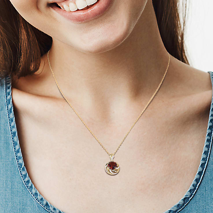 2 1/7 CT TGW Garnet, White Topaz and Diamond Pendant with Chain in
Yellow Plated Sterling Silver