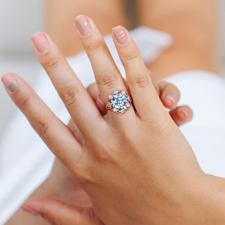 4 4/5 CT TGW London Blue, Sky Blue Topaz with White Topaz Floral Ring in
Rose Plated Sterling Silver