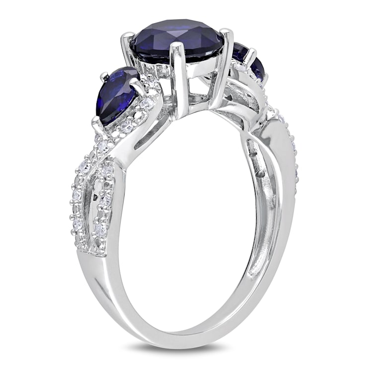 2 1/3 CTW Created Blue Sapphire and 1/6 CT TW Diamond Floral Ring in
Sterling Silver
