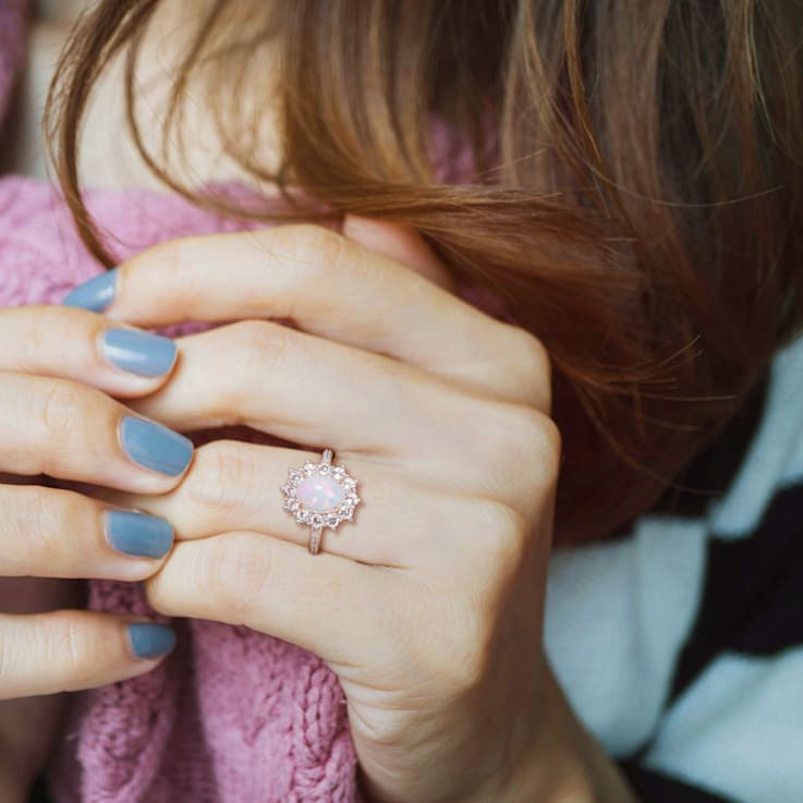 2 1/6 CT TGW Blue Ethiopian Opal, White Topaz and Diamond Accent Ring in
Rose Plated Sterling Silver
