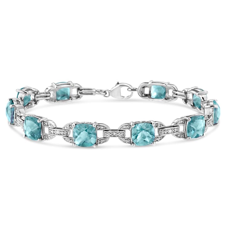 .925 Sterling Silver 7x7 mm Cushion Cut Blue Topaz and 1/20ctw Round Cut
Diamond Tennis Bracelet