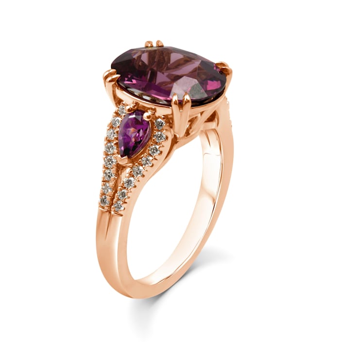 18KP 1/5 CTW Diamond Engagement Ring With 3 3/4 CTW Oval Garnet &
1/2 CTW Pear Garnet