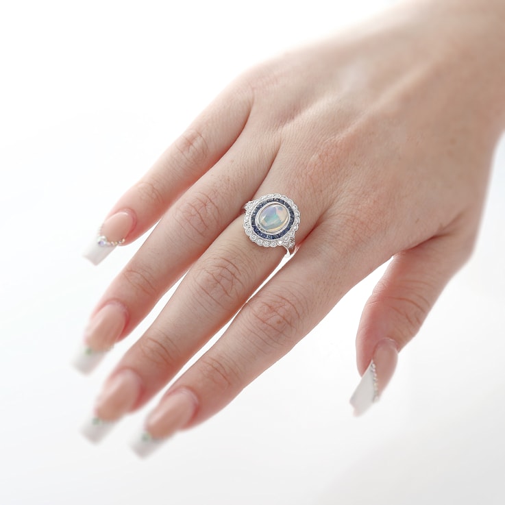 Beverley K 18K White Gold 0.35ctw Diamond and 0.76ctw Sapphire Ring set
with a 1.15ct Opal Center