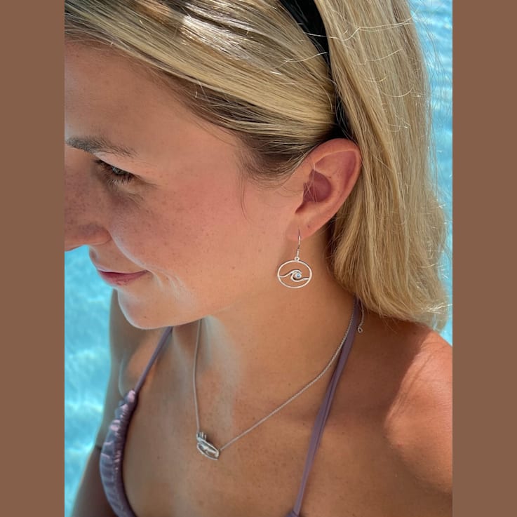 Sterling Silver Wave Dangle Earrings with Blue CZ Accents.