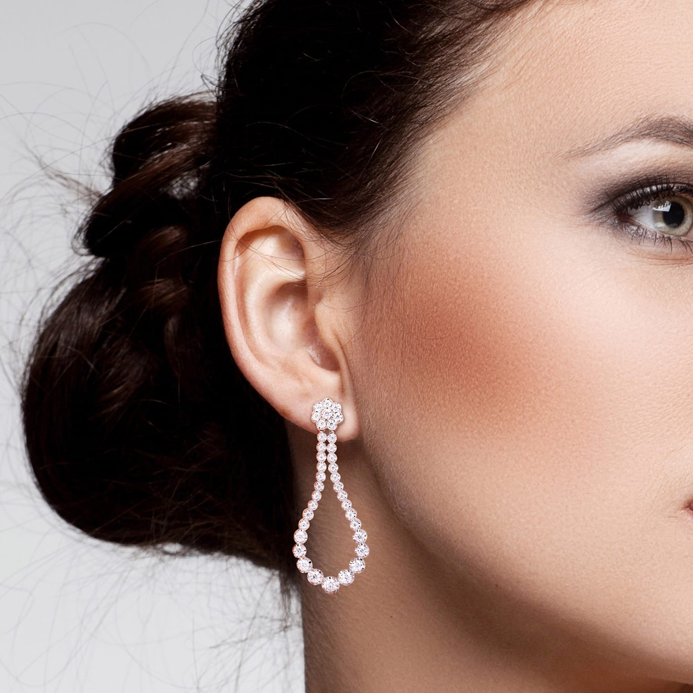 Model wearing teardrop style moissanite earrings 