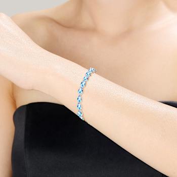 Blue Topaz Color CZ Pear Shape Tennis Bracelet In White Rhodium Over Brass
