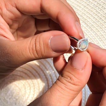 Pear Shape Lab Created Opal with Moissanite Accents Rhodium Over
Sterling Silver Halo Ring