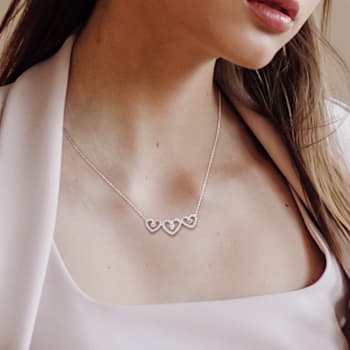 1/2 CT TGW White Topaz and 1/5 CT TW Diamond Triple Heart Necklace in
Sterling Silver