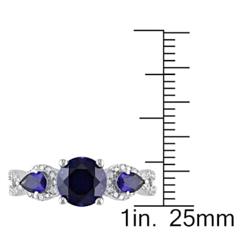 2 1/3 CTW Created Blue Sapphire and 1/6 CT TW Diamond Floral Ring in
Sterling Silver
