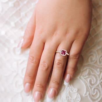 1 CT TGW Created Ruby and 1/7 CT TW Diamond Halo Ring in 10K Yellow Gold