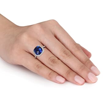 5 3/4 CT TGW Created Blue Sapphire and 1/10 CT TW Diamond Halo Ring in
Sterling Silver