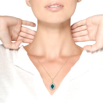 14K Yellow Gold 6x4mm Emerald and 1/5ctw Round Diamond Halo Pendant
w\chain 18"