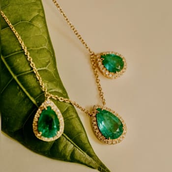 5.97Cts Colombian Emerald-pear cut, 0.56 diamond, crafted in 18K Yellow
Gold drop-necklace
