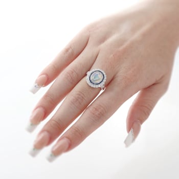 Beverley K 18K White Gold 0.35ctw Diamond and 0.76ctw Sapphire Ring set
with a 1.15ct Opal Center