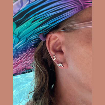 Sterling Silver Wave Stud Earrings with Blue CZ Accents.
