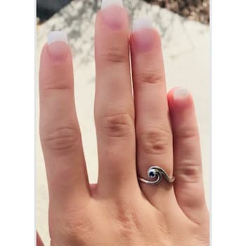 Sterling Silver Wave Ring with Blue CZ Center.