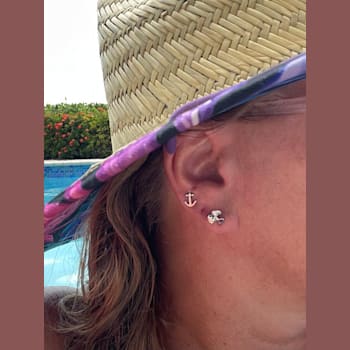 Sterling Silver Propeller Stud Earrings with Blue CZ Accents.