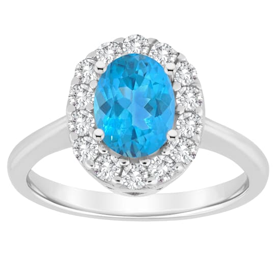 Oval Blue Topaz Halo Ring With With White Topaz In Sterling Silver