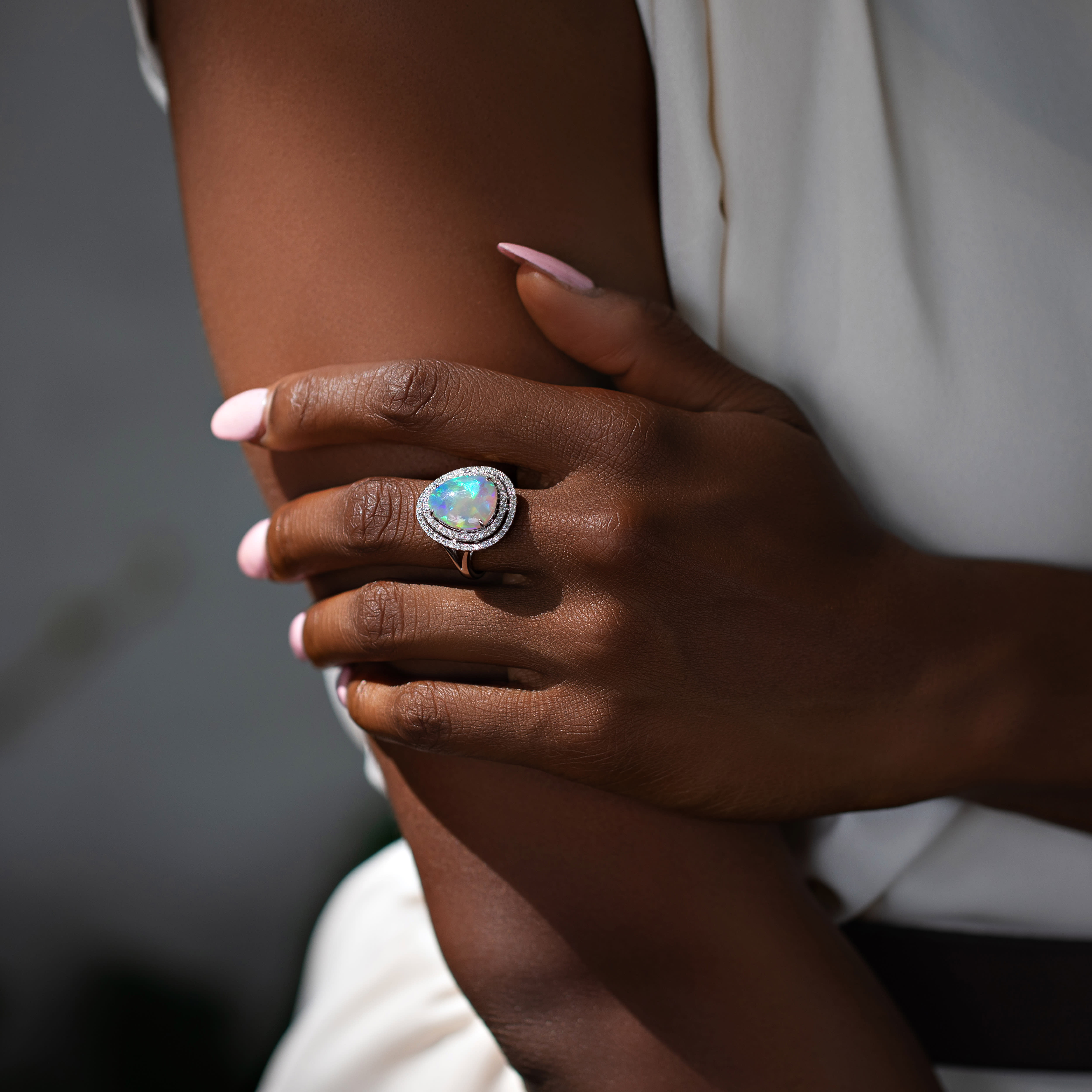 woman wearing opal gemstone ring 