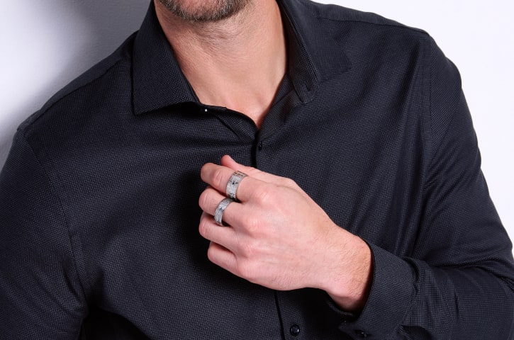 man wearing silver rings 