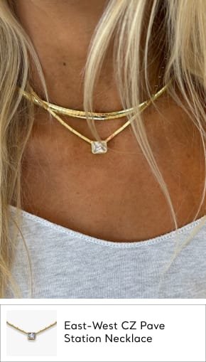 woman wearing cz station necklace in gold