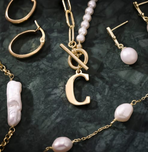 different pearl product types laying on green background