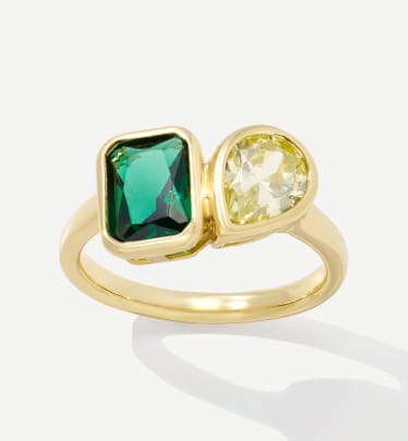 gold ring with green and white stones 