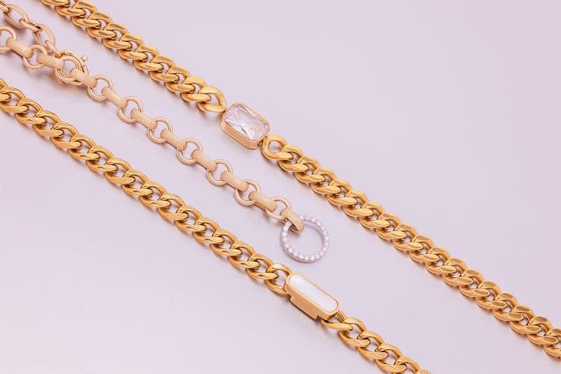 a group of long, gold necklaces 