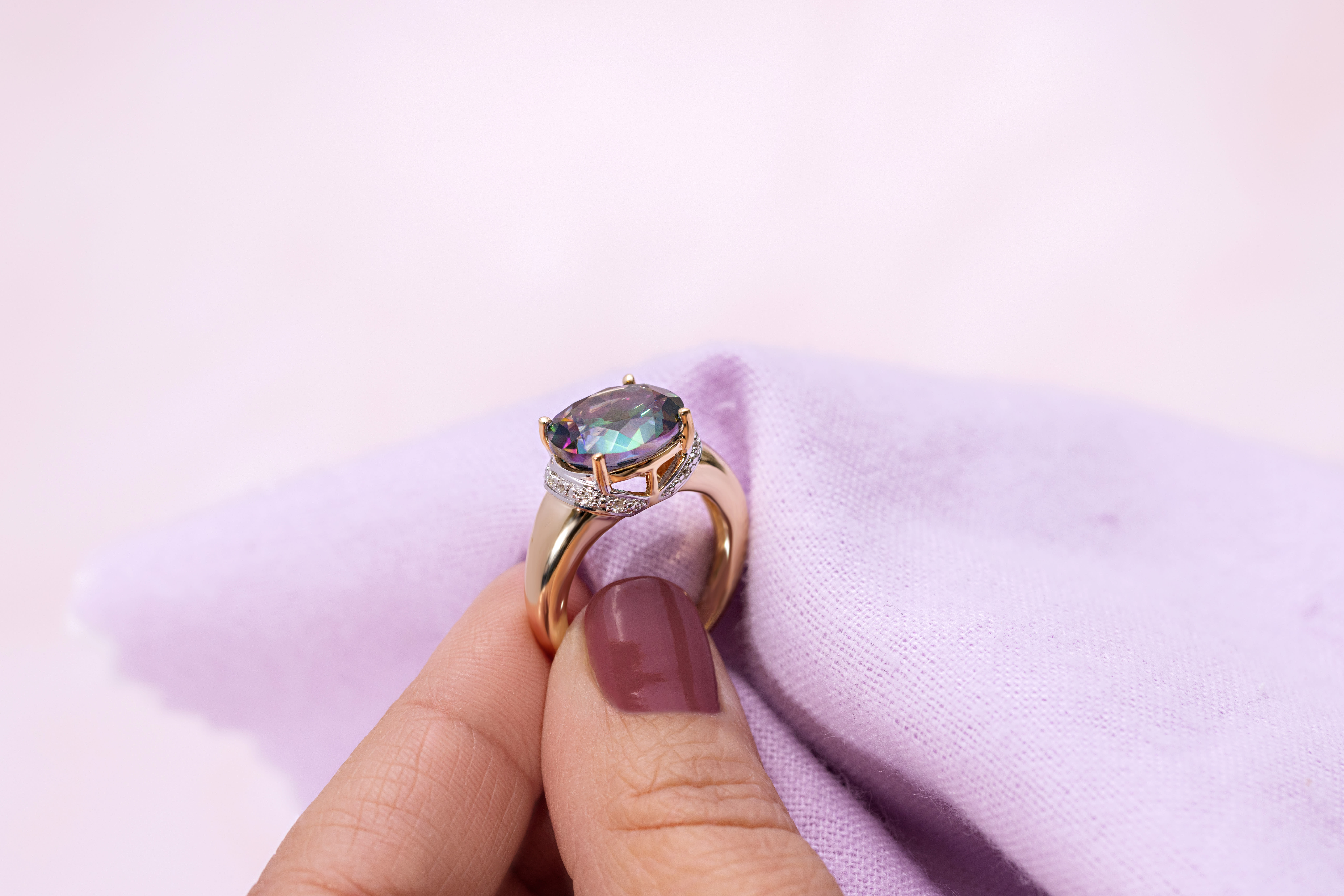 a multicolored gemstone and gold ring