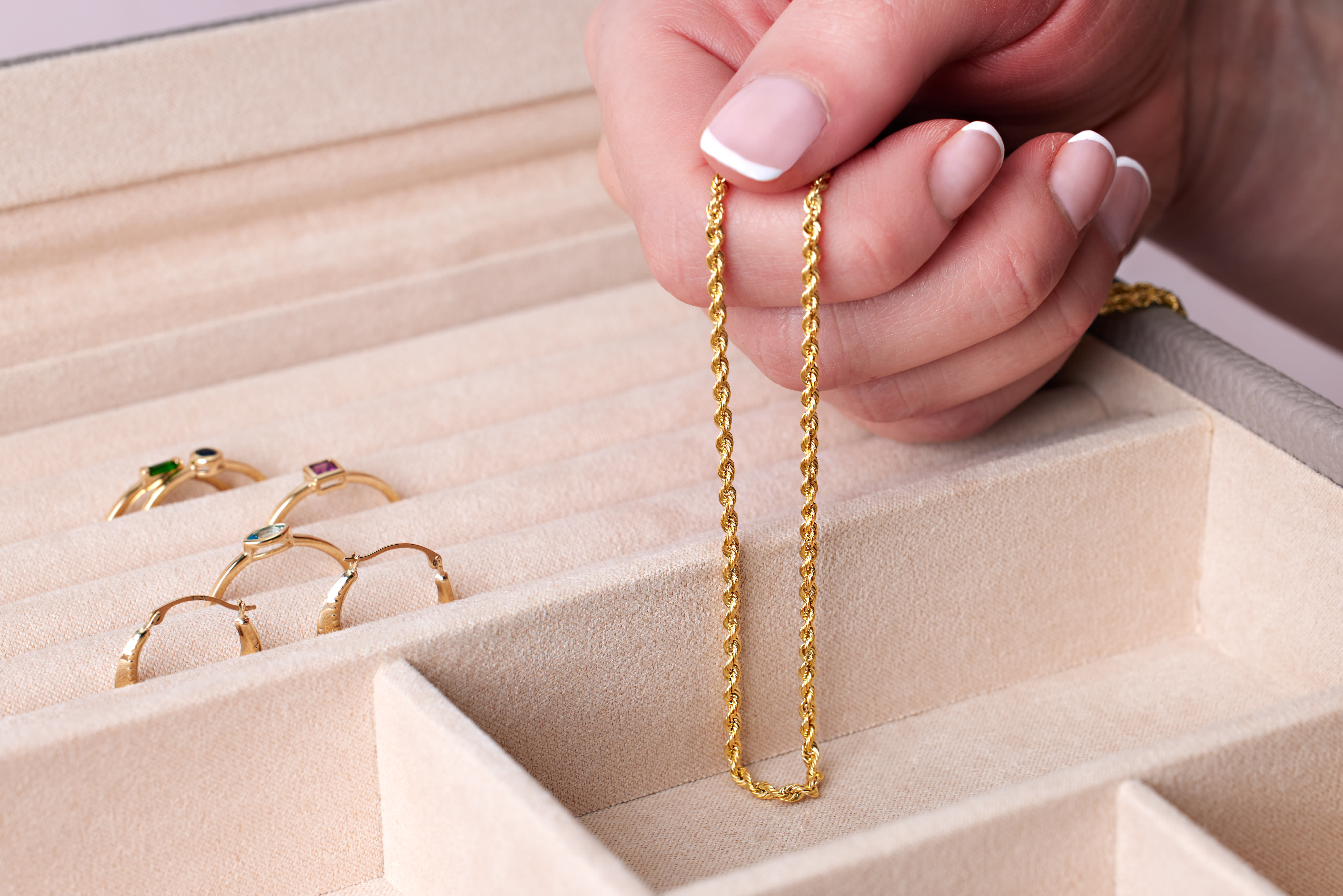 a gold chain necklace and a collection of gold rings