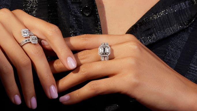 white stone rings on womans hands