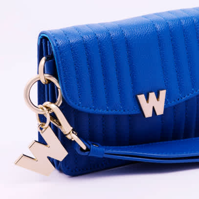 blue handbag with gold hardware