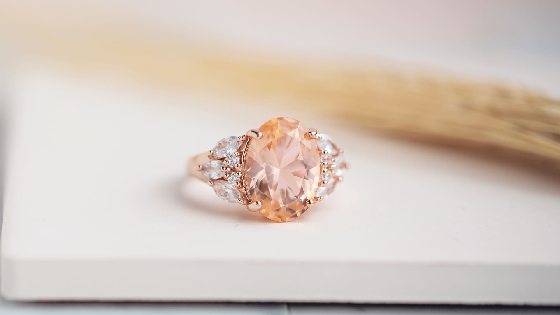 an oval and peach colored morganite ring