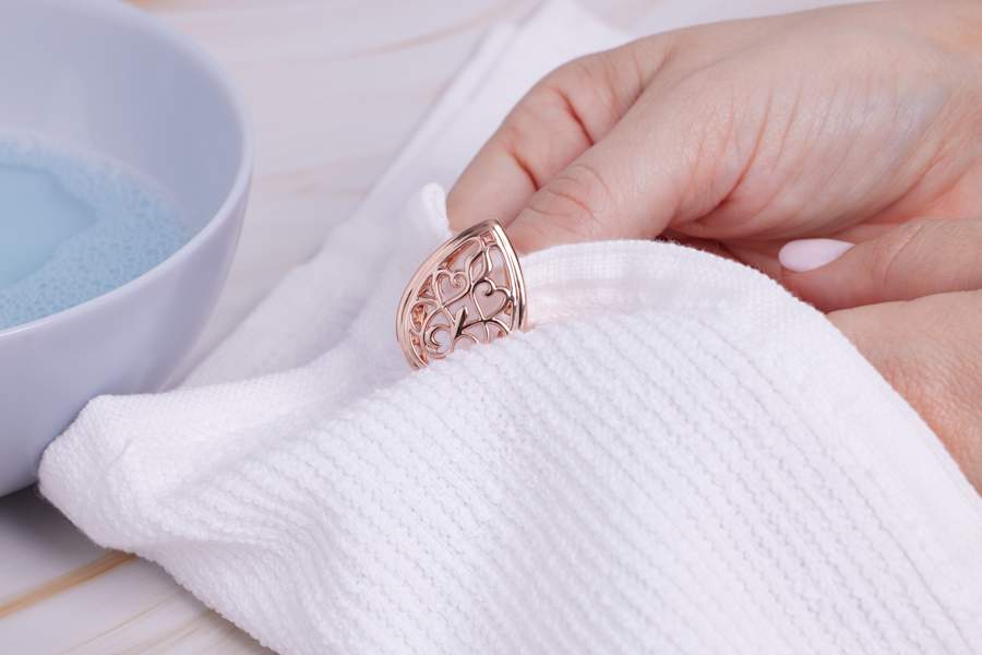 a copper jewelry piece is dried off 