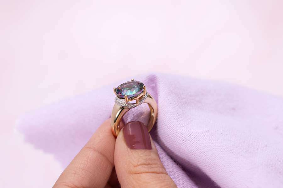 a multicolored gemstone and gold ring 