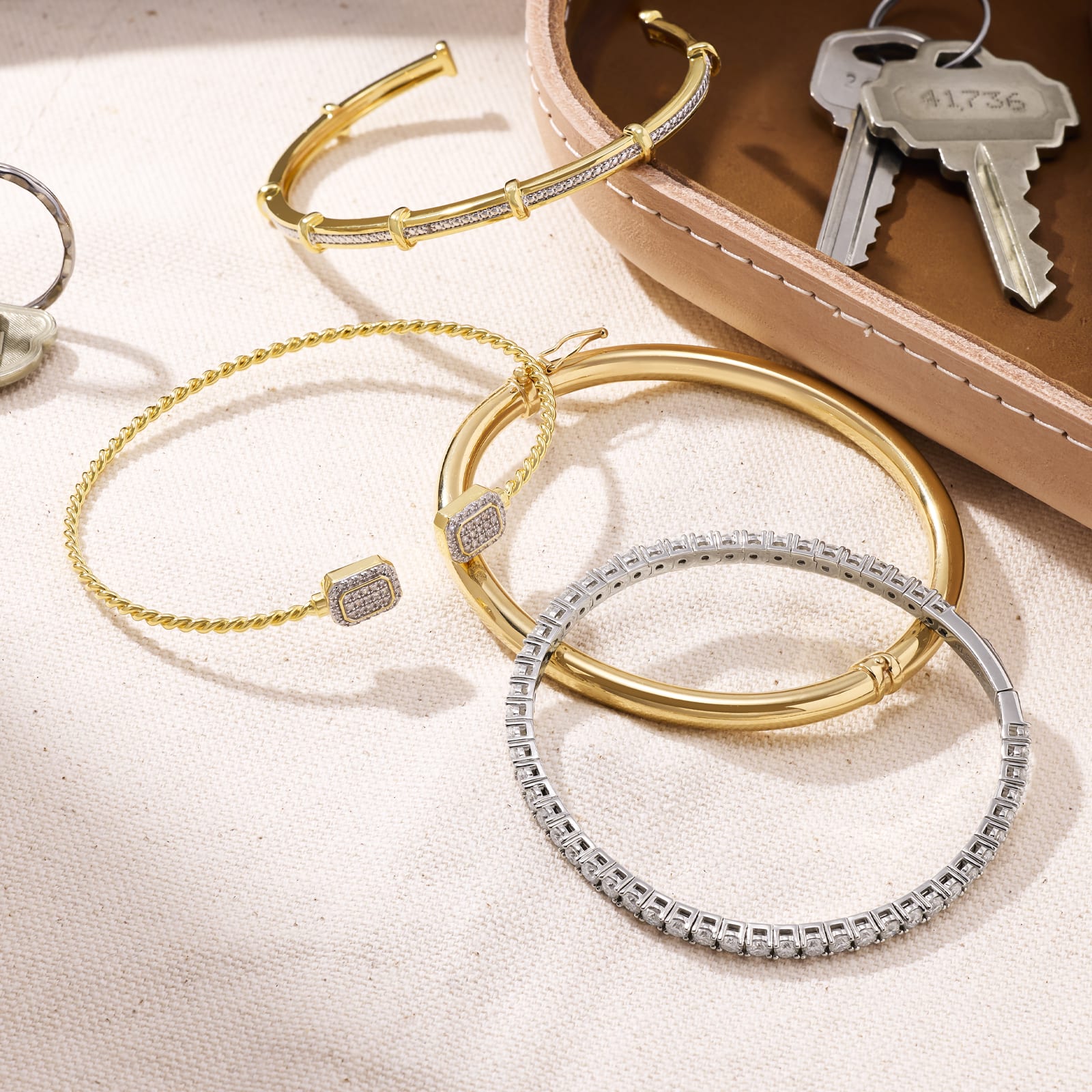 bangle bracelets on a table with keys 