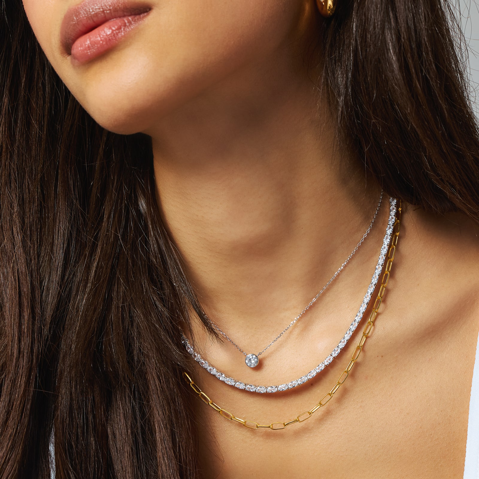 woman wearing layered necklaces 