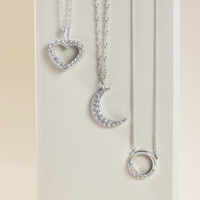 set of symbolic necklaces in white metal and diamond 