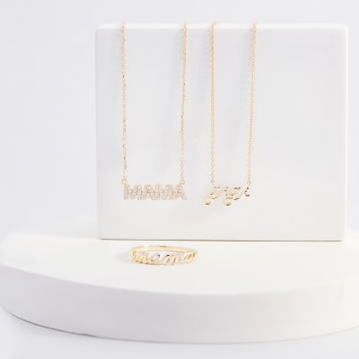 two personalized gold necklaces and a ring