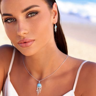woman wearing larimar silver jellyfish earrings and pendant necklace 